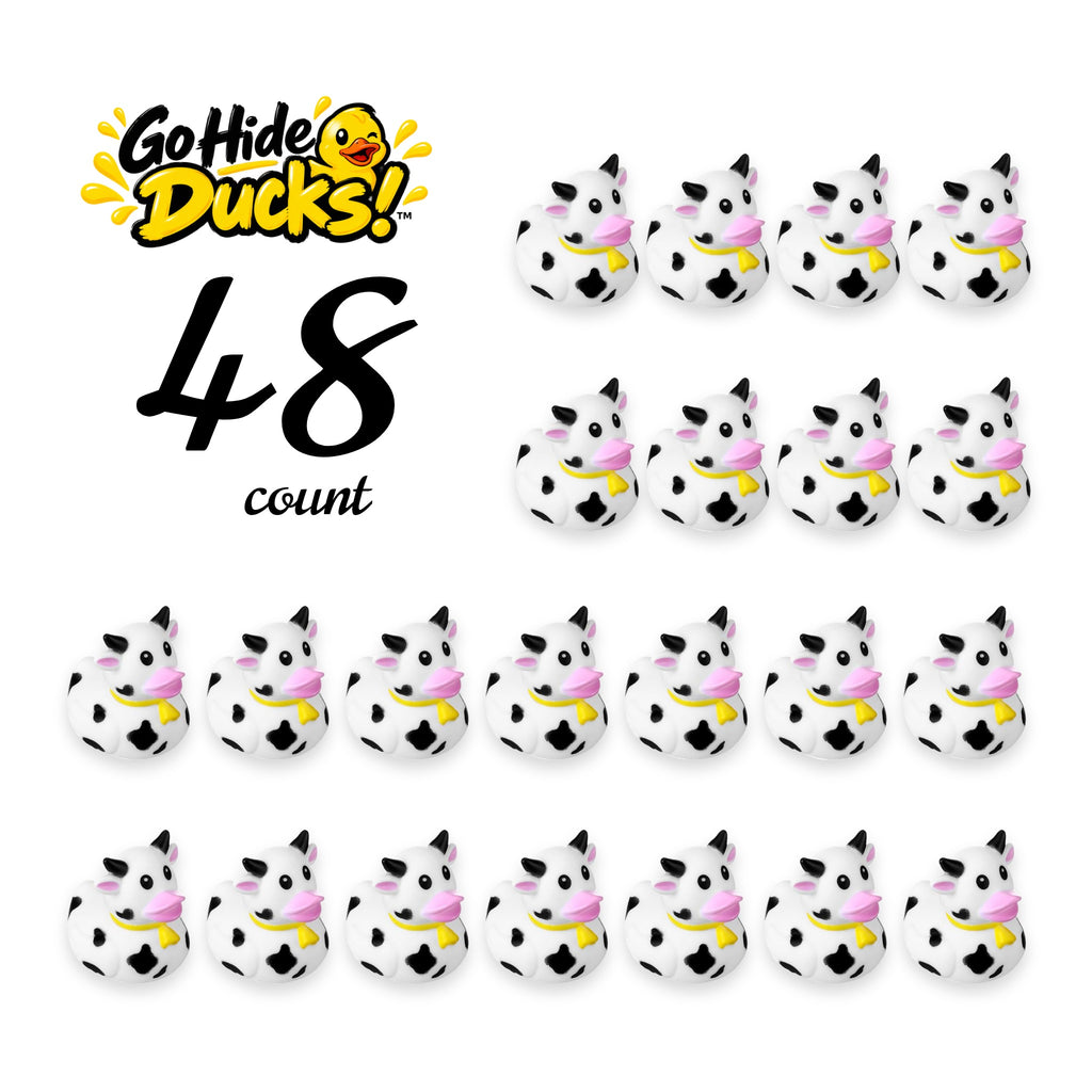 Small rubber ducks with black-and-white cow print and pink accents